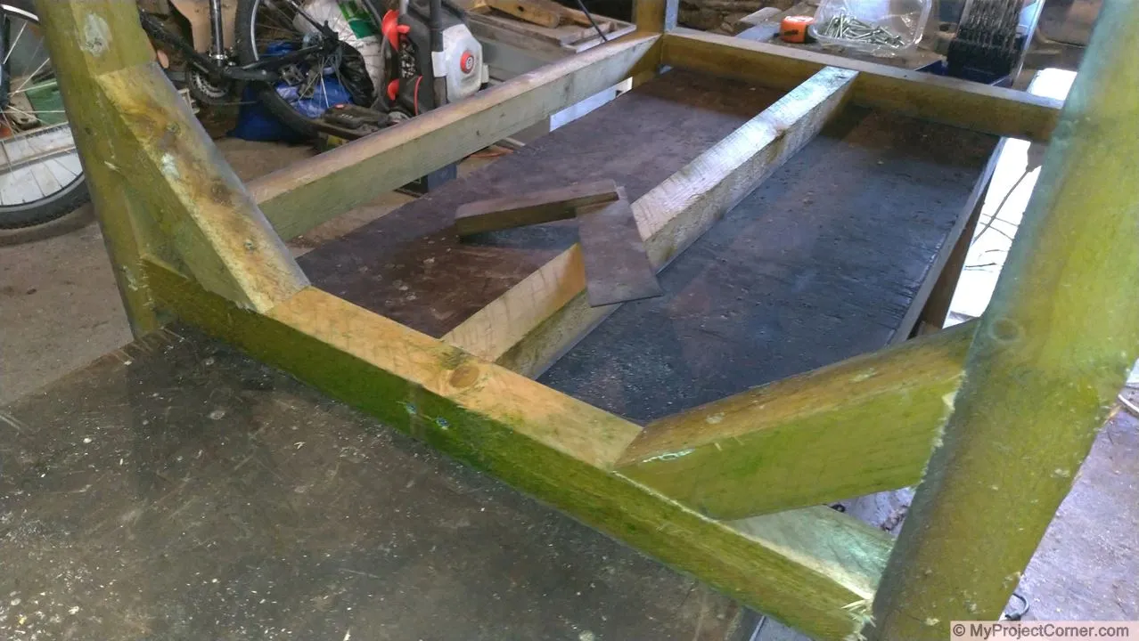 Wooden framework for recycled barrel planter with bracing