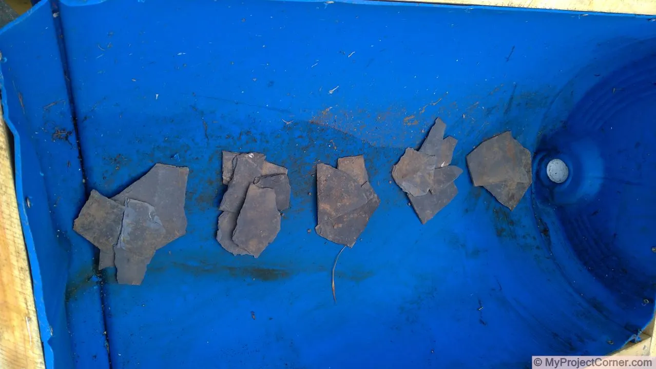 Recycled barrel planter slates over holes