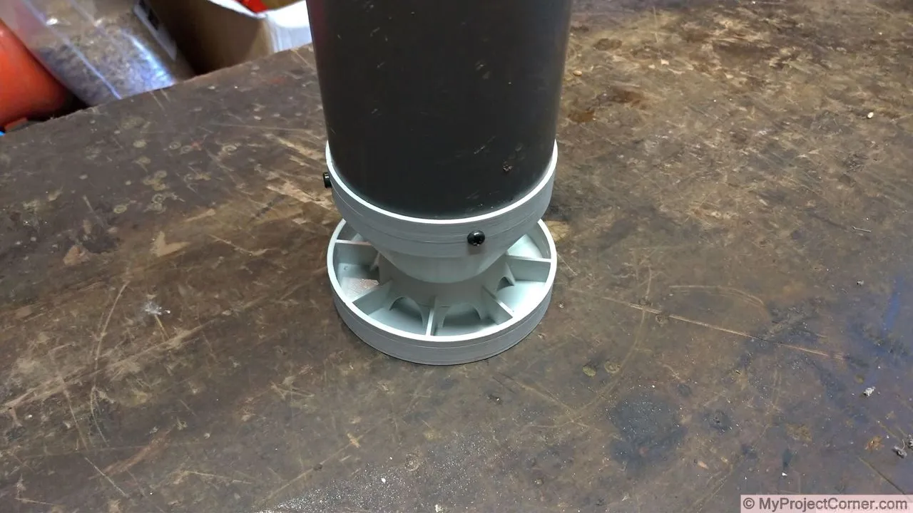 The chicken feeder screwed to the pvc pipe