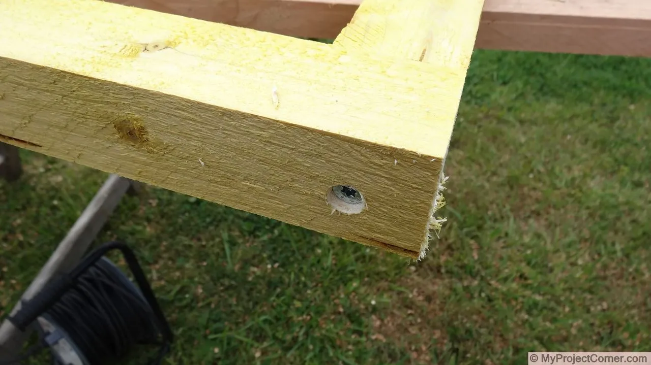 Screwing together the wooden frame for the chicken slaughter station