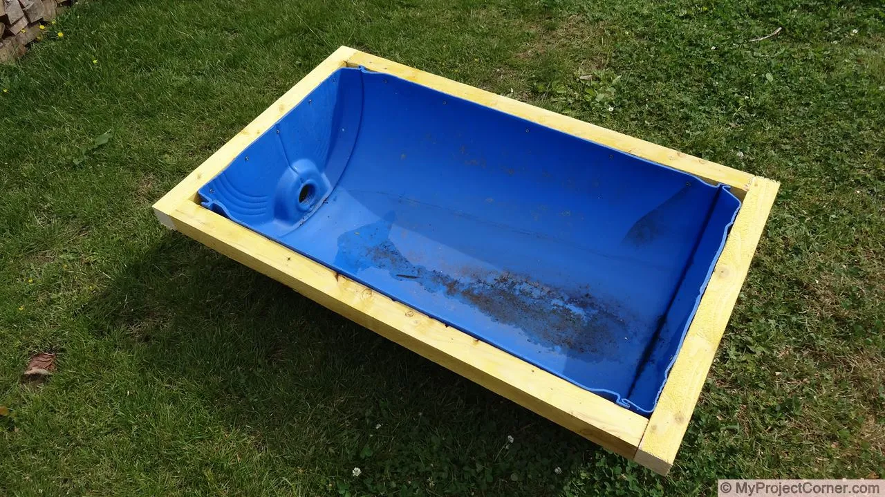 Attaching recycled plastic barrel to wooden frame for the chicken slaughter station