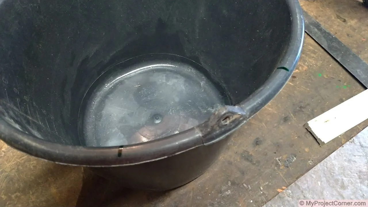 Marking out top of plastic bucket used for chicken slaughter cone