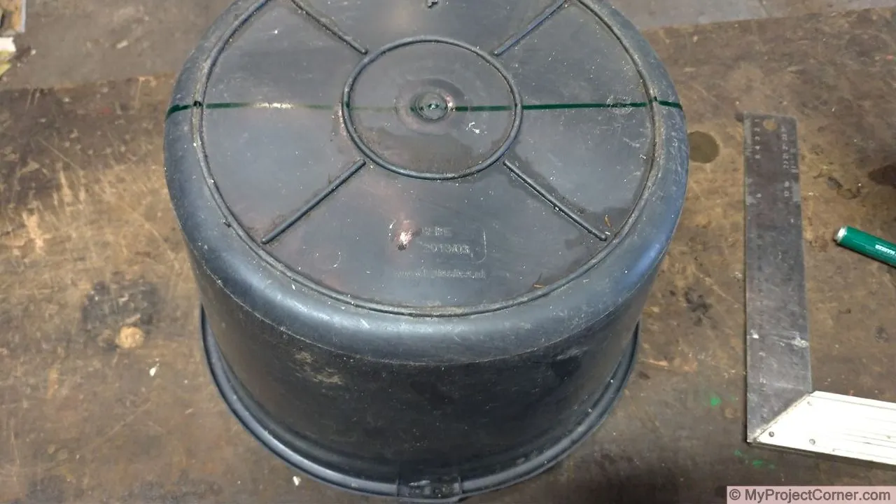 Marking out bottom of plastic bucket used for chicken slaughter cone