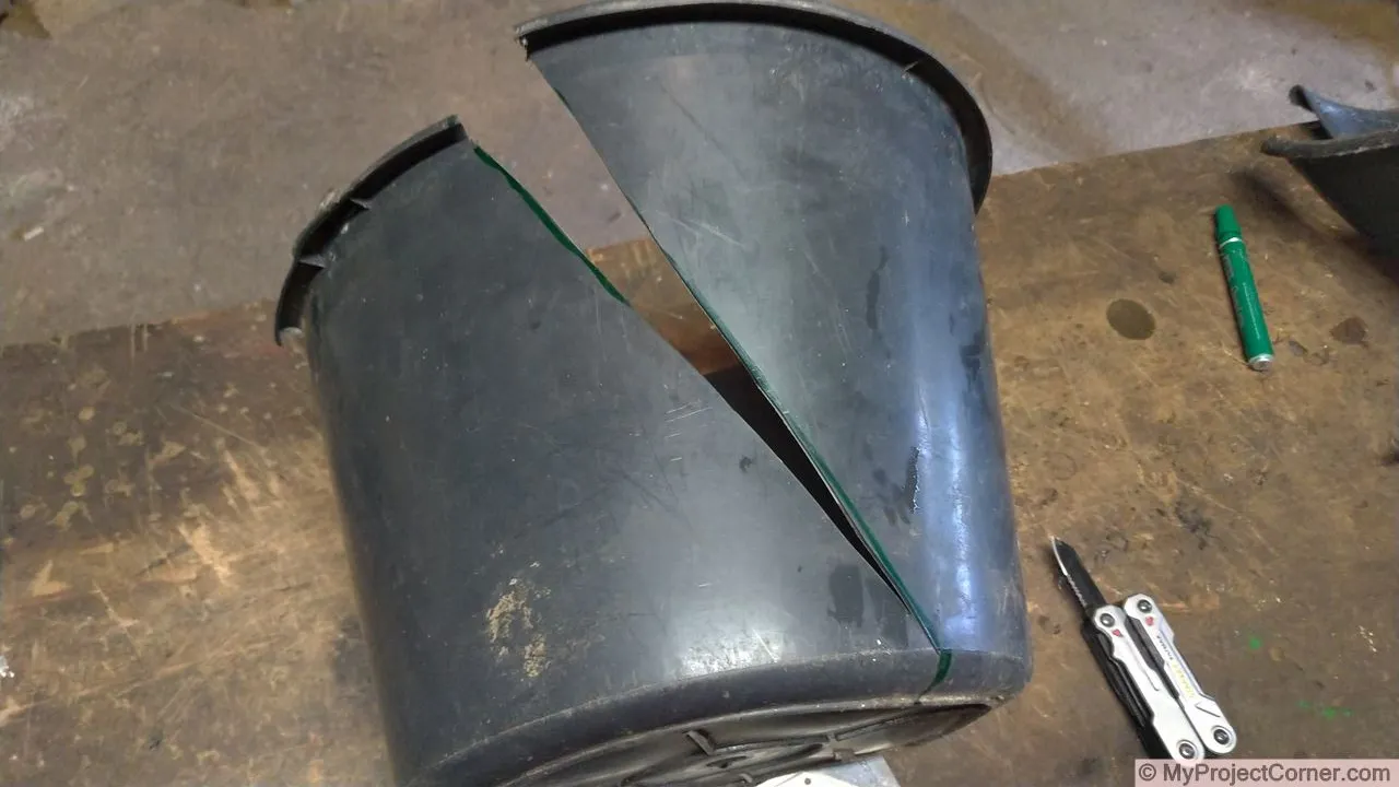 Cutting the plastic bucket used for chicken slaughter cone