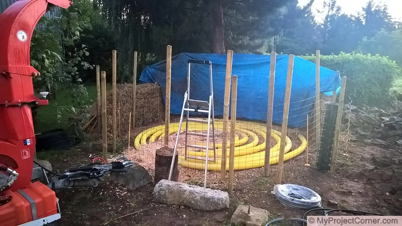 blowing wood chips into compost heating pile