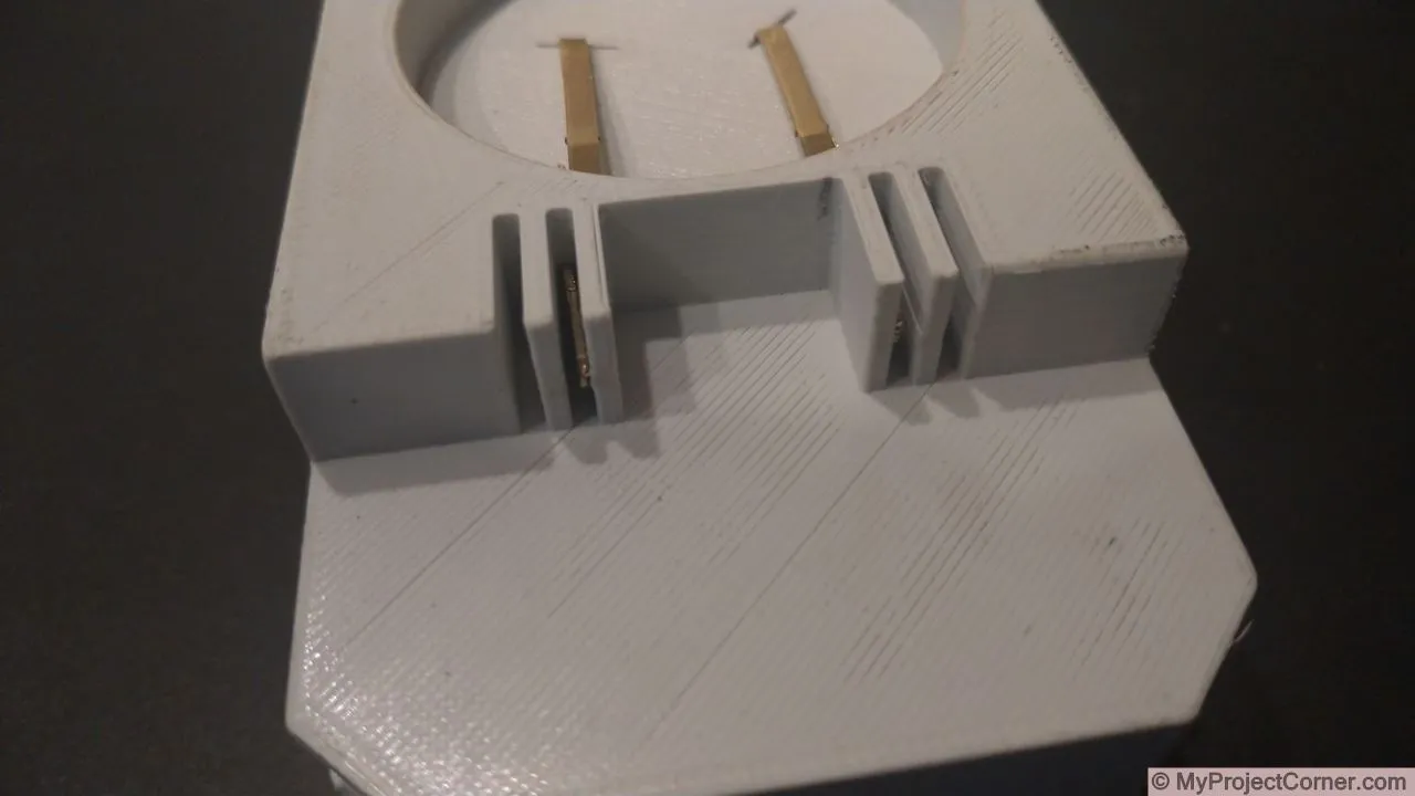 inserting battery terminals and spring for battery adaptor