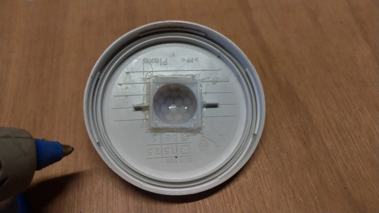 Using hot glue to attach the mouse detector motion sensor